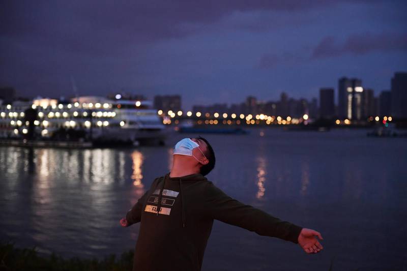 A man exercises at a riverside park by the Yangtze River in Wuhan on March 26, 2020. Reuters