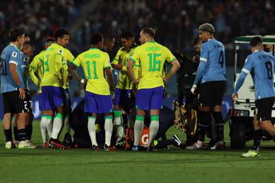 Brazil players stand next to Neymar before he went off injured during the 2026 World Cup South American qualification match against Uruguay. AFP