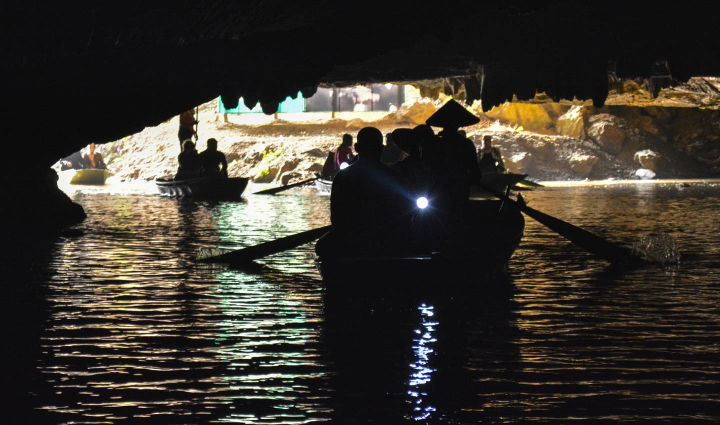 Tourists float down an underground river in Tam Coc. Photo: Ronan O'Connell