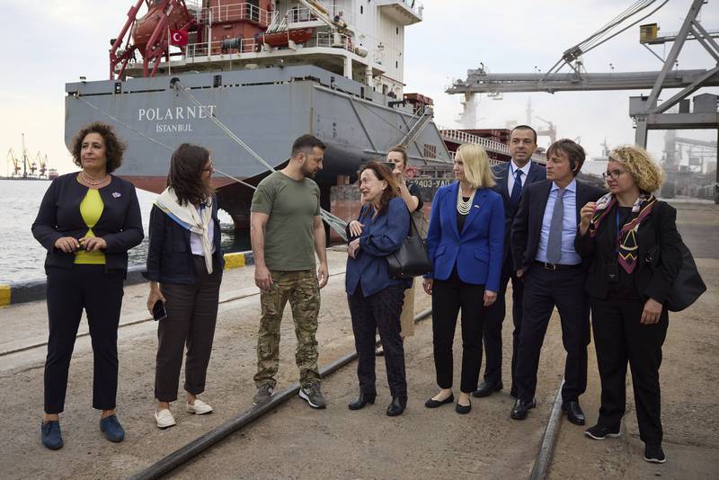 Ukrainian President Volodymyr Zelenskyy (C), with ambassadors and UN officials, visits a port in Chornomork during the loading of grain on to a Turkish ship, near Odesa. AP