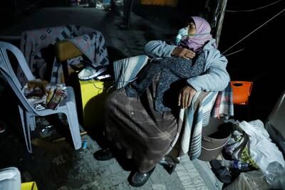 A woman rests after an earthquake in Antakya in Hatay province, Turkey.