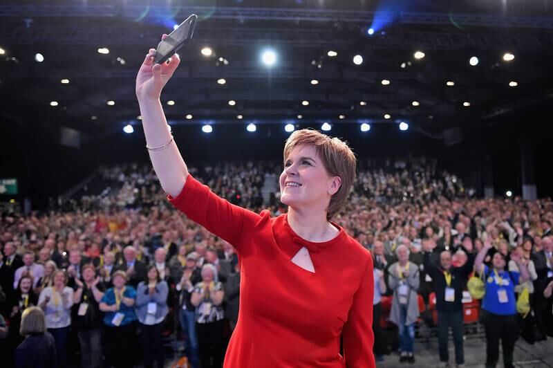 Ms Sturgeon is seen taking a selfie on stage at the Scottish National Party conference in Aberdeen in October 2015. Getty