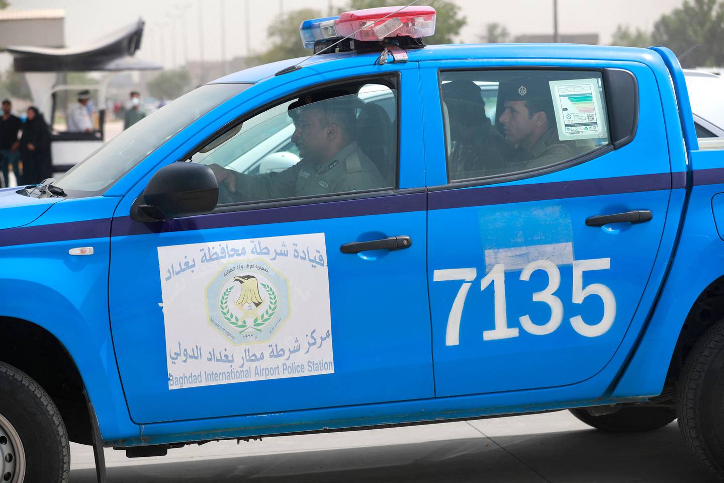 A police car transports Jim Fitton to the Karkh Appeal Court in Baghdad, on June 6. AFP