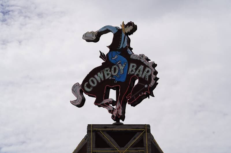 A neon cowboy sign on the roof of a popular bar in Jackson, Wyoming. Willy Lowry / The National