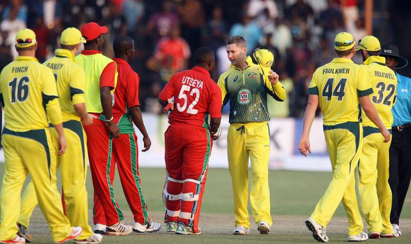 Australia captain Michael Clarke, centre right, shakes hands with Zimbabwe's Prosper Utseya at the end of their one-day international match at the Harare Sports Club on August 31, 2014. Jekesai Njikizana / AFP
