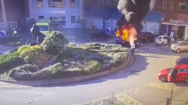 Surveillance camera footage shows a man extinguishing a burning taxi following the explosion outside Liverpool Women's Hospital in the UK. Reuters