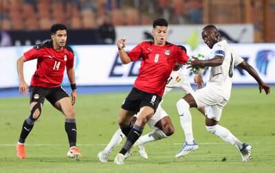 Naby Keita (R) of Guinea in action against Egyptian players Omar Gaber (L) and Emam Ashour (C) during the Africa Cup of Nations (AFCON) qualifying soccer match between Egypt and Guinea in Cairo, Egypt, 05 June 2022.   EPA / KHALED ELFIQI