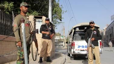 Pakistani security officials stand guard at a checkpoint, one day after the blast in Balochistan. EPA