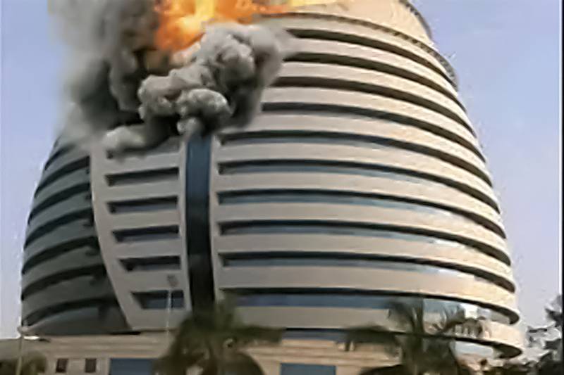 The start of a fire that later engulfed the entire tower housing a major oil company in Khartoum. AFP