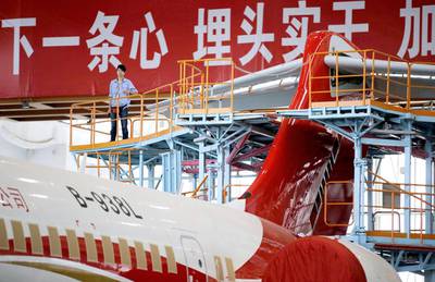A technician inspects an ARJ21-700 aircraft at the Comac factory in Shanghai. China launched the ARJ21 project in 2002 in an attempt to break into the Western-dominated aircraft market and is targeting the domestic market and flights to Southeast Asia. Carlos Barria / Reuters
