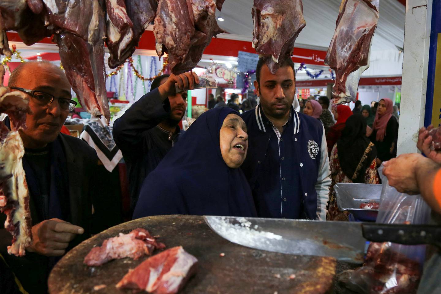 Shoppers at a butcher's shop n Giza, Egypt. Reuters. 