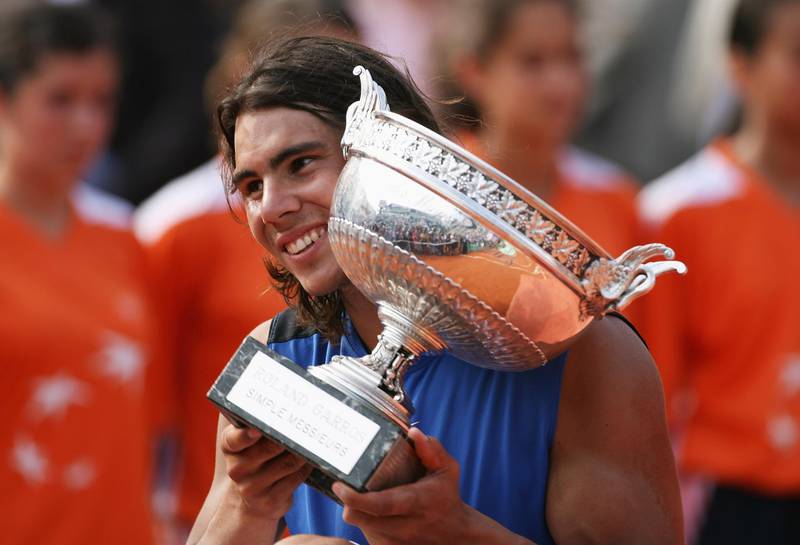 PARIS - JUNE 11:  Rafael Nadal of Spain holds the trophy after defeating Roger Federer of Switzerland during the Men's Singles Final on day fifteen of the French Open at Roland Garros on June 11, 2006 in Paris, France.  (Photo by Clive Brunskill/Getty Images)