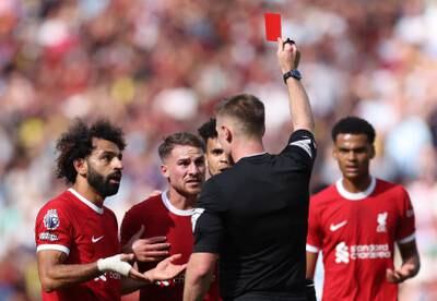 Liverpool's Alexis Mac Allister, centre, is shown a red card. Reuters