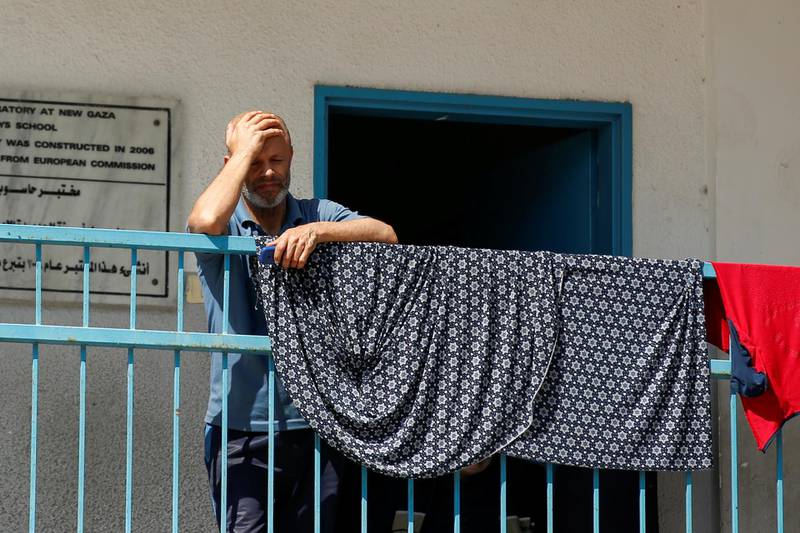 A Palestinian man, who fled his home due to Israeli air and artillery strikes stands at a United Nations-run school where he takes refuge, in Gaza City May 18. Reuters
