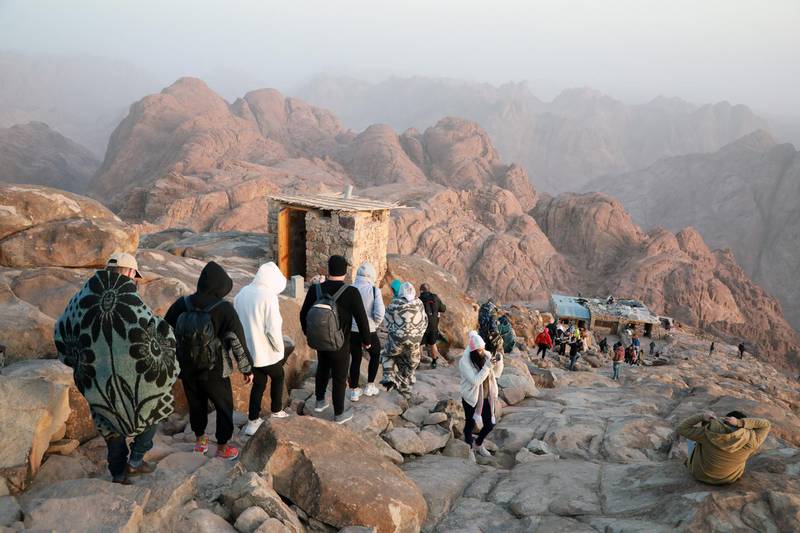 Tourists walk towards the monastery of St Catherine after watching the sunrise on top of Mount Moses, in Saint Catherine city of Egypt's South Sinai Governorate. EPA