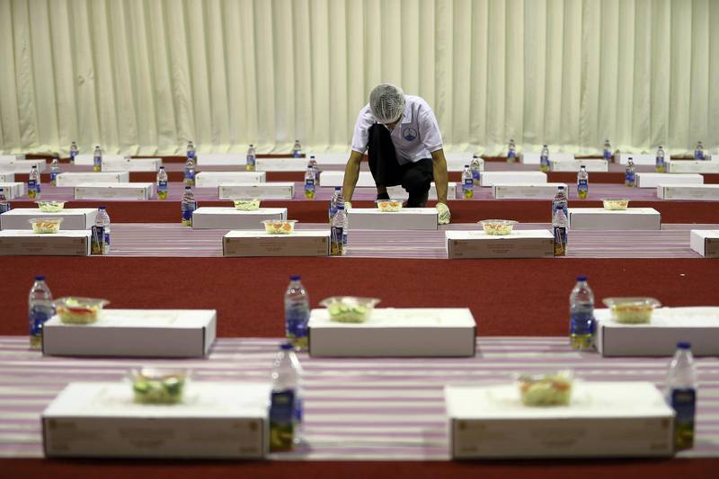 ABU DHABI,  UNITED ARAB EMIRATES , May 6 – 2019 :- Worker arranging food packets for the Iftar on the First day of Ramadan at the Sheikh Zayed Grand Mosque in Abu Dhabi. ( Pawan Singh / The National ) For News/Online/Big Picture/ Instagram