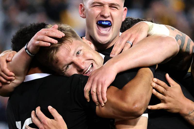New Zealand's Jordie Barrett celebrates a try with teammates. AFP