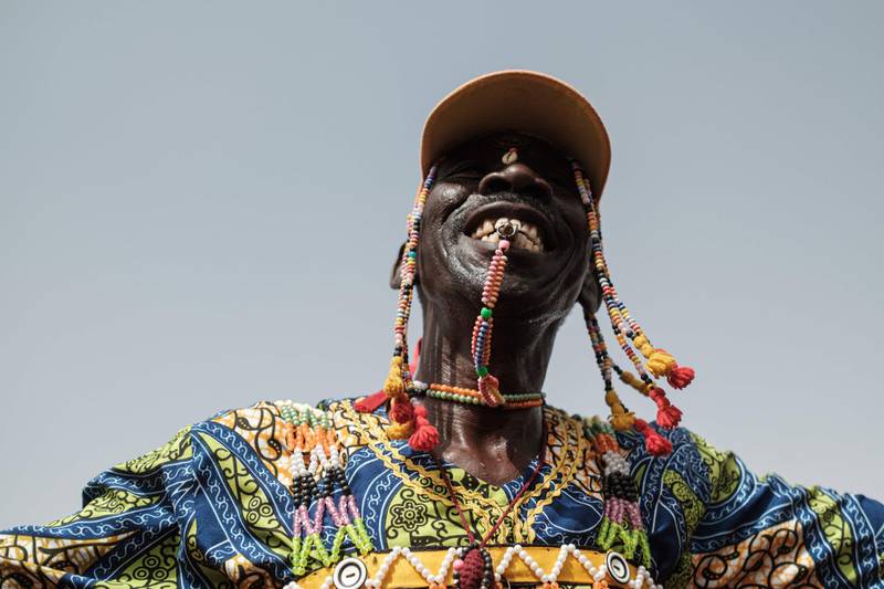 A member of traditional music and dance group performs before a rally for supporters of Sudan's ruling Transitional Military Council (TMC) in the village of Abraq, about 60km northwest of Khartoum.   AFP