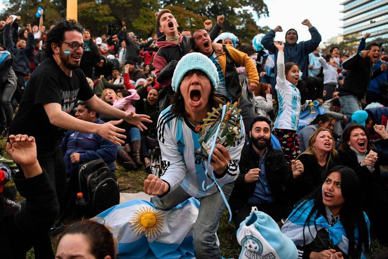 Fans of Argentina celebrate as they watch the FIFA World Cup Russia 2018 match between Argentina and Nigeria on a giant screen at San Martin square in Buenos Aires. AFP