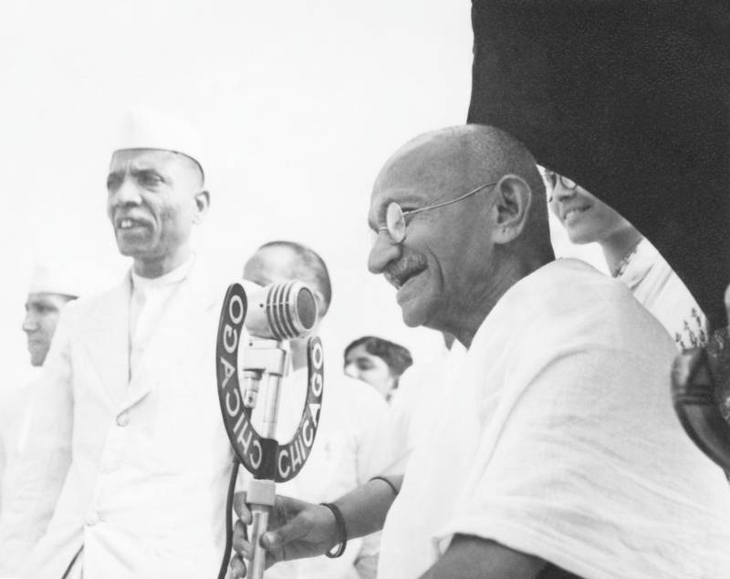 Indian statesman and activist Mohandas Karamchand Gandhi (1869 - 1948) speaking into a microphone at Pune, 1944.  (Photo by Dinodia Photos/Getty Images)