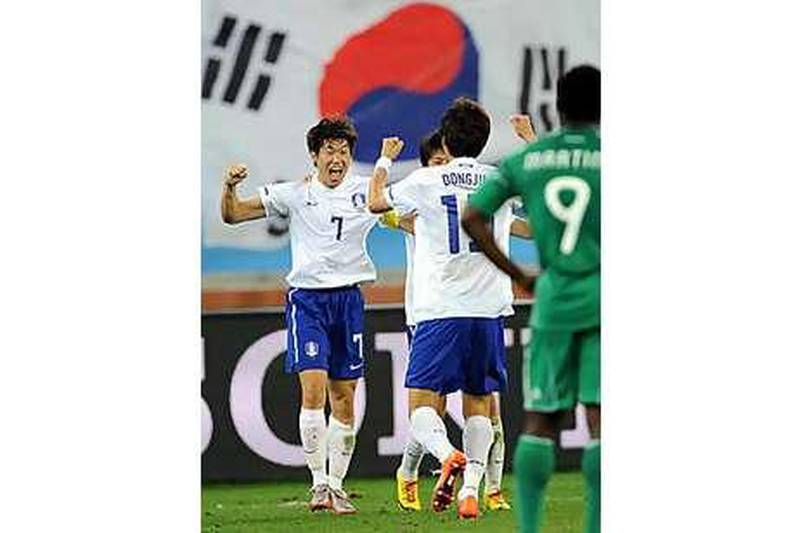 South Korea's Ji-sung Park, left, celebrates with teammates after a 2-2 draw against Nigeria saw them progress to the last 16.
