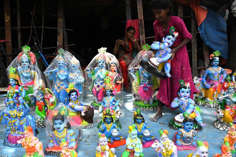 Idols of Krishna being sold ahead of the festival. AFP