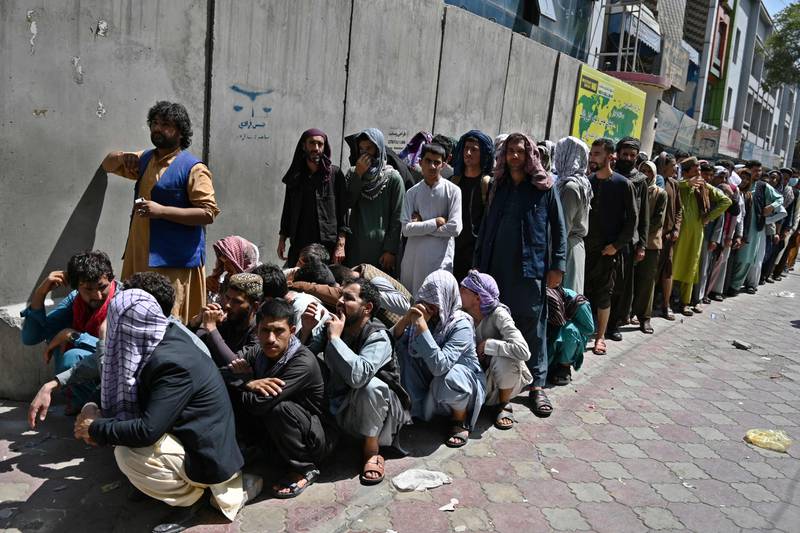 People queue outside a bank to withdraw money in the Shar-e-Naw district of Kabul. AFP