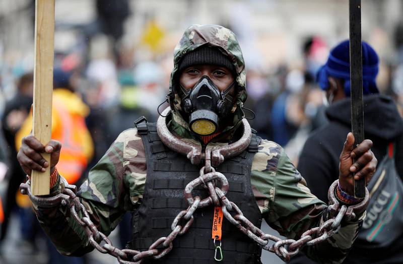 A demonstrator wears chains and a mask. Reuters