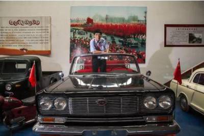 Luo Wenyou stands in a Hongqi, or Red Flag car; limousines that were custom-built for the Chinese leadership and used by visiting dignitaries at his museum for classic cars in Beijing. James Wasserman for The National
