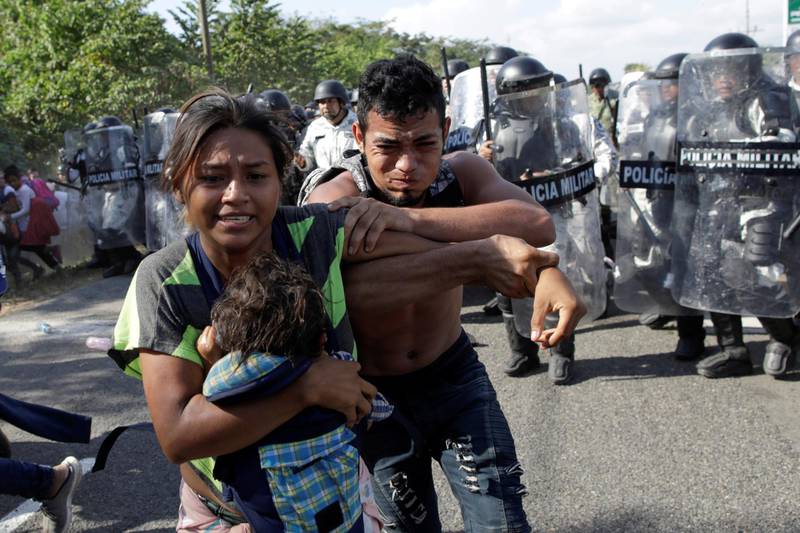 Migrants react as members of the security forces approach to them, near Frontera Hidalgo, Chiapas, Mexico. Reuters