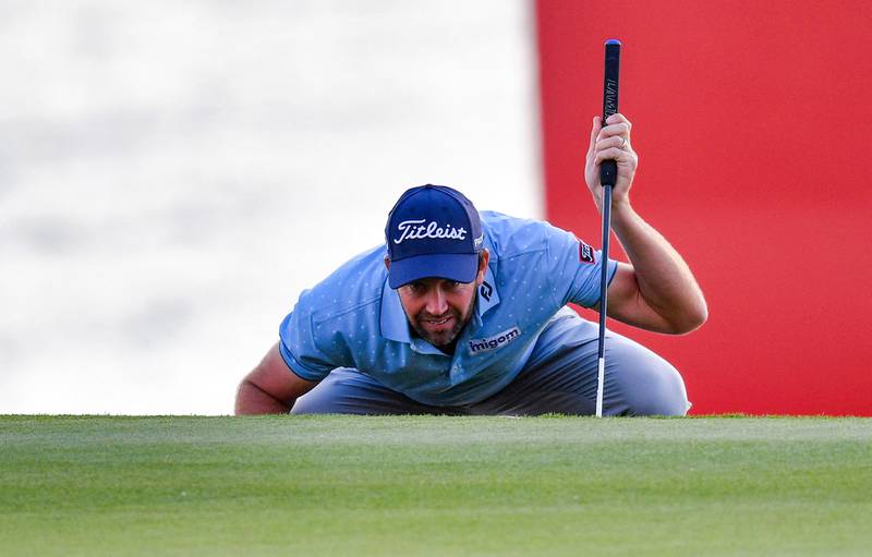 Scott Jamieson of Scotland studies the green at the 18th hole during the third round of the Abu Dhabi HSBC championship at Yas Links Golf Course, on January 22, 2022 in Abu Dhabi, the capital of the United Arab Emirates.  (Photo by Ryan LIM  /  AFP)