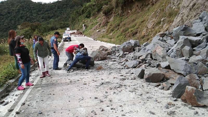 Villagers clear boulders along a road in the Cordillera region after the quake. EPA