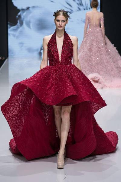 A ballgown in crimson with undulating hem and billowing skirt, encrusted with crystal flowers. Courtesy Michael Cinco and Couturissimo
