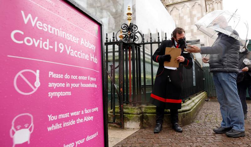 Patients are greeted by Abbey staff outside a vaccination centre at Westminster Abbey in London. Reuters