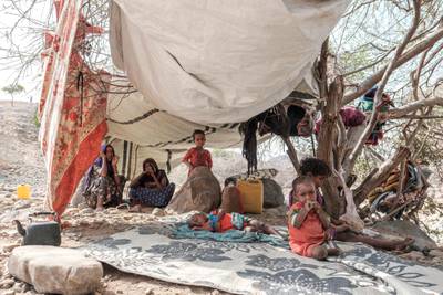 Internally displaced people sit in a tent in a makeshift camp in the village of Erebti, Ethiopia. AFP