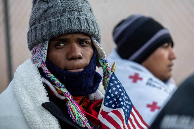 A Venezuelan migrant bundles up against the cold in El Paso. Getty / AFP