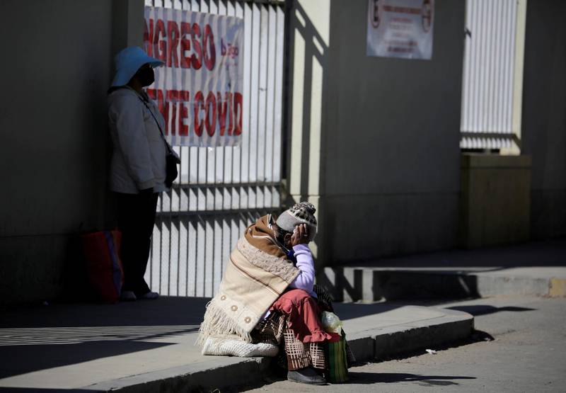 A woman who is suspected of having Covid-19 sits outside El Norte Hospital, La Paz, Bolivia. Reuters