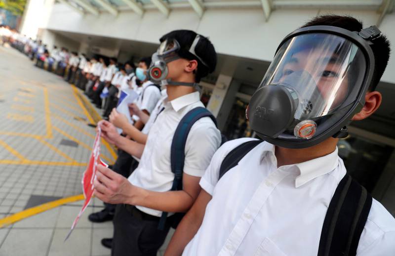 Secondary school students wearing masks join a human chain protesting against what they say is police brutality against protesters, after clashes at Wan Chai district in Hong Kong, China September 9, 2019. REUTERS/Amr Abdallah Dalsh
