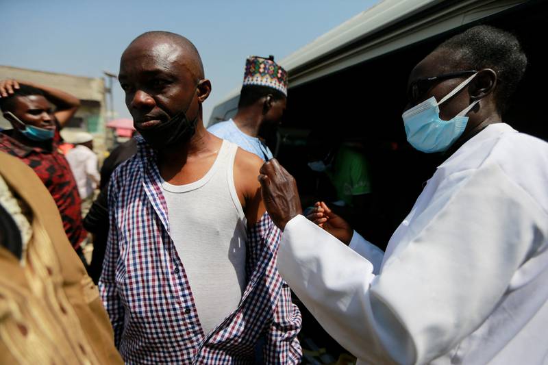 A man is vaccinated at Wuse market in Abuja, Nigeria. Reuters