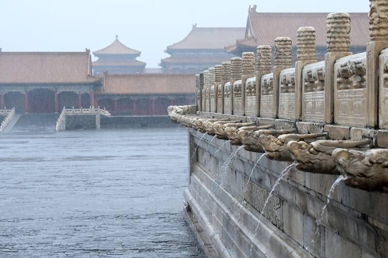 Rainwater flows from gargoyles inside the Forbidden City as rainstorms hit Beijing, China, last month. EPA