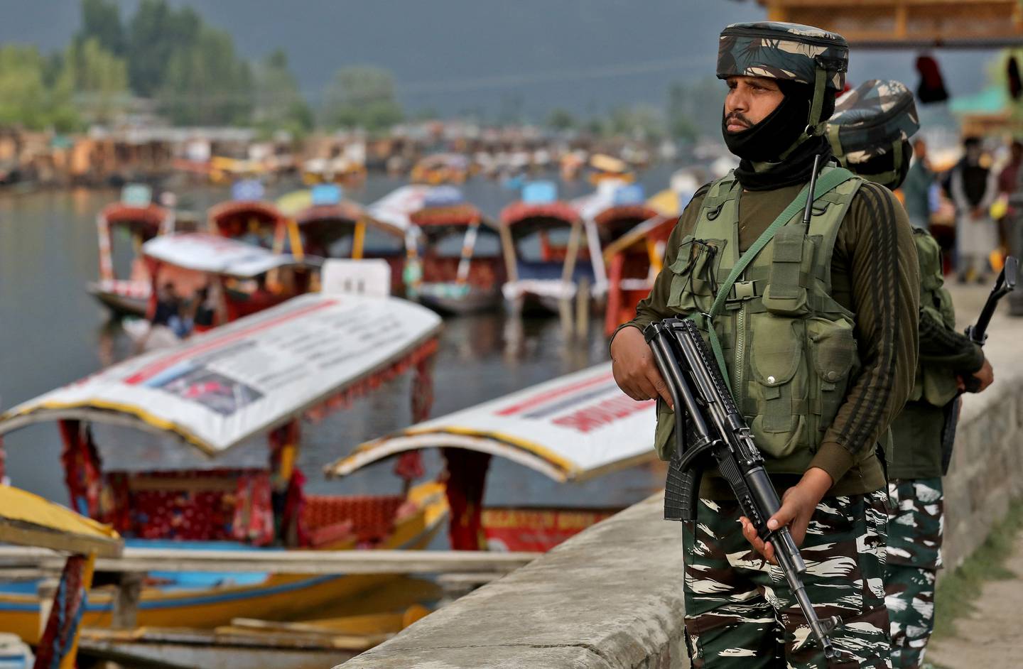 India's Central Reserve Police Force (CRPF) personnel stand guard on the banks of Dal Lake, a famous tourist attraction in Srinagar, Kashmir, on May 26, 2022. Reuters