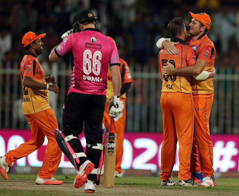 Graeme Smith of Virgo Super Kings and Brett Lee of Virgo Super Kings celebrate after winning the Masters Champions League match between Leo Lions and Virgo Super Kings at Sharjah Cricket Stadium in Sharjah .  ( Satish Kumar / The National  )