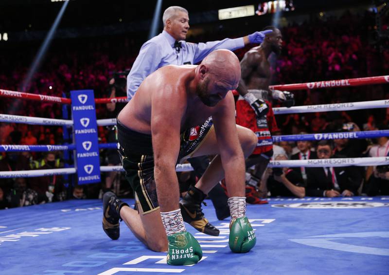 Tyson Fury gets up after he was knocked down twice in the fourth round. AP