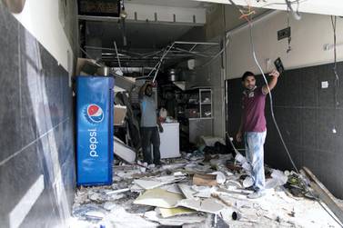The clear-up gets underway after a gas explosion caused Dh200,000 of damage to an Ajman cafe. Reem Mohammed/The National