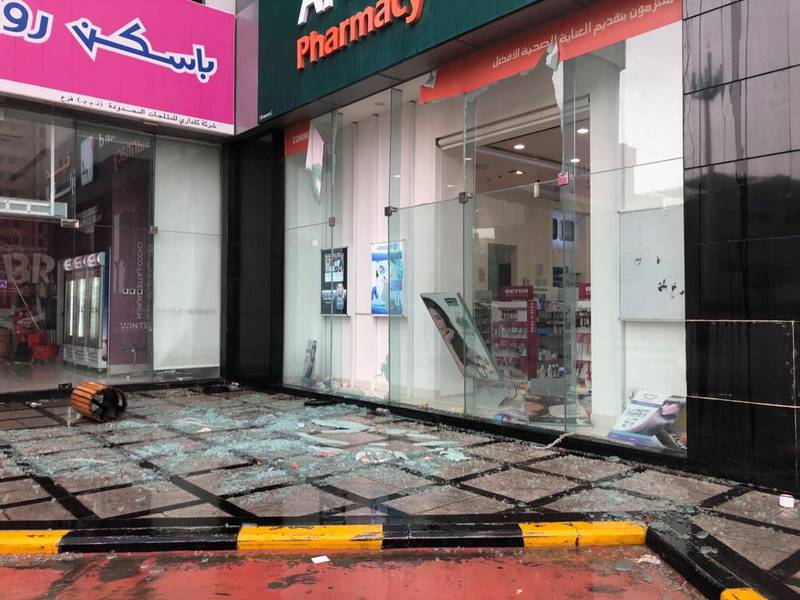 Hail and strong wind causes the windows of a pharmacy to shatter in Dubai. The National