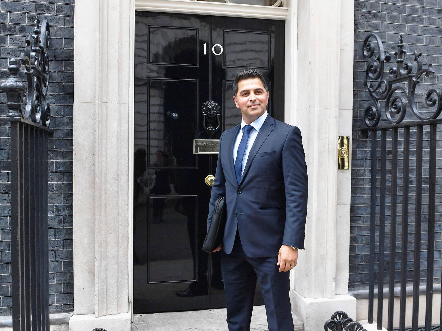 Dr Waheed Arian, an emergency medicine and radiology specialist, arrives at No 10 Downing Street in London for the 70th anniversary of the NHS reception. John Stillwell / Getty