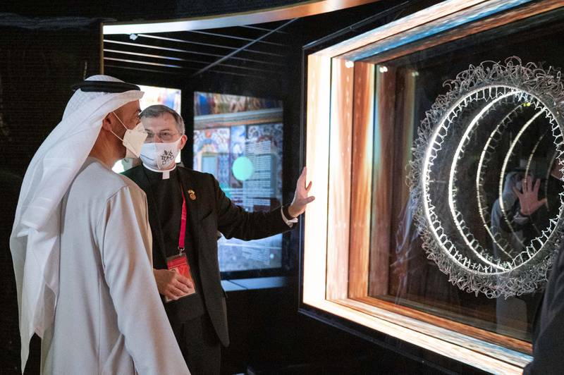 Sheikh Mohamed is shown exhibits in the Holy See Pavilion.