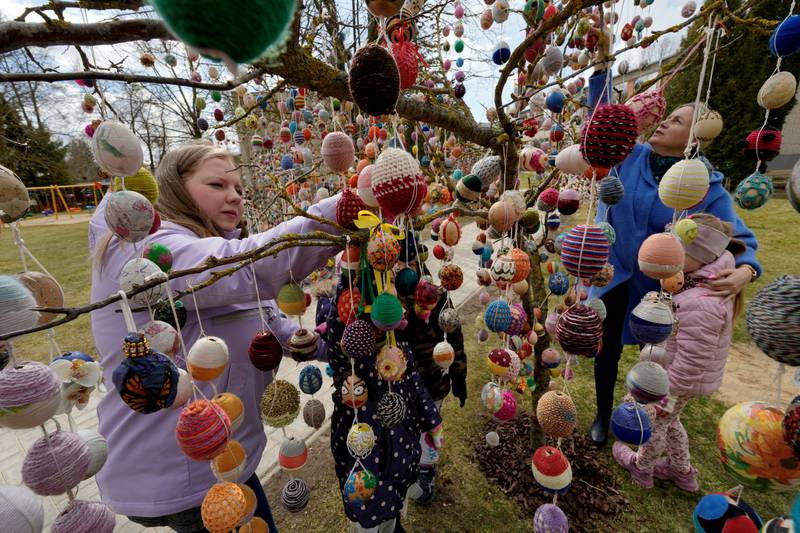 People decorate a tree with Easter eggs in  a kindergarten in Seduva, Lithuania. Reuters