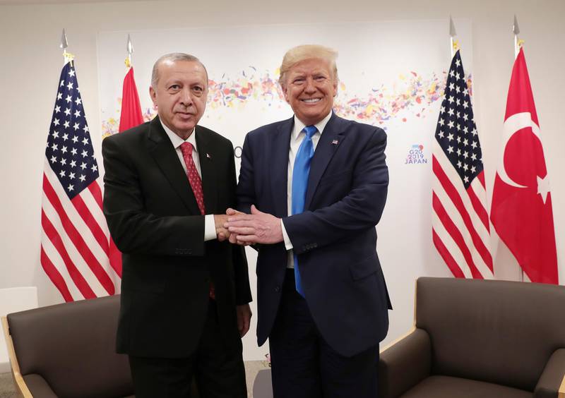 Turkey's President Recep Tayyip Erdogan, left, and U.S. President Donald Trump, right, shake hands during a meeting on the sidelines of the G-20 summit in Osaka, Japan, Saturday, June 29, 2019. (Presidential Press Service/Pool Photo via AP)