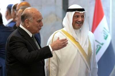 Iraqi Foreign Minister Fuad Hussein, left, welcomes Kuwaiti Foreign Minister Sheikh Salem Al Sabah in Baghdad on Sunday. AP